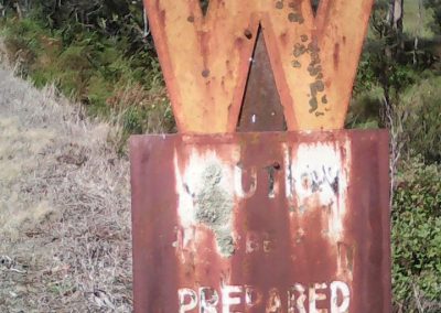 Rusting railway signs on the trail.